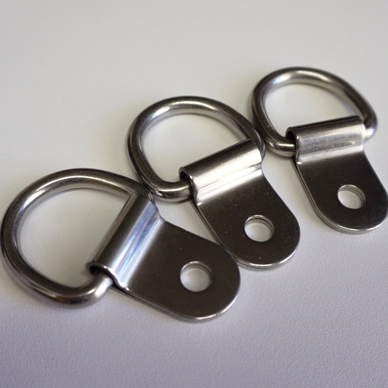 Three metal eyelets on a white background
