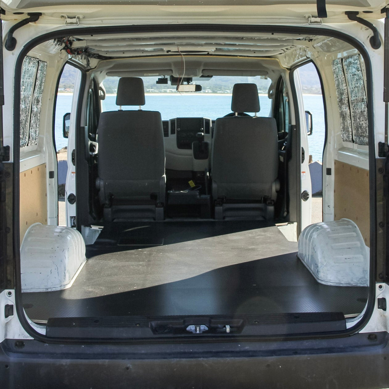Van interior with flatbed at a scenic location
